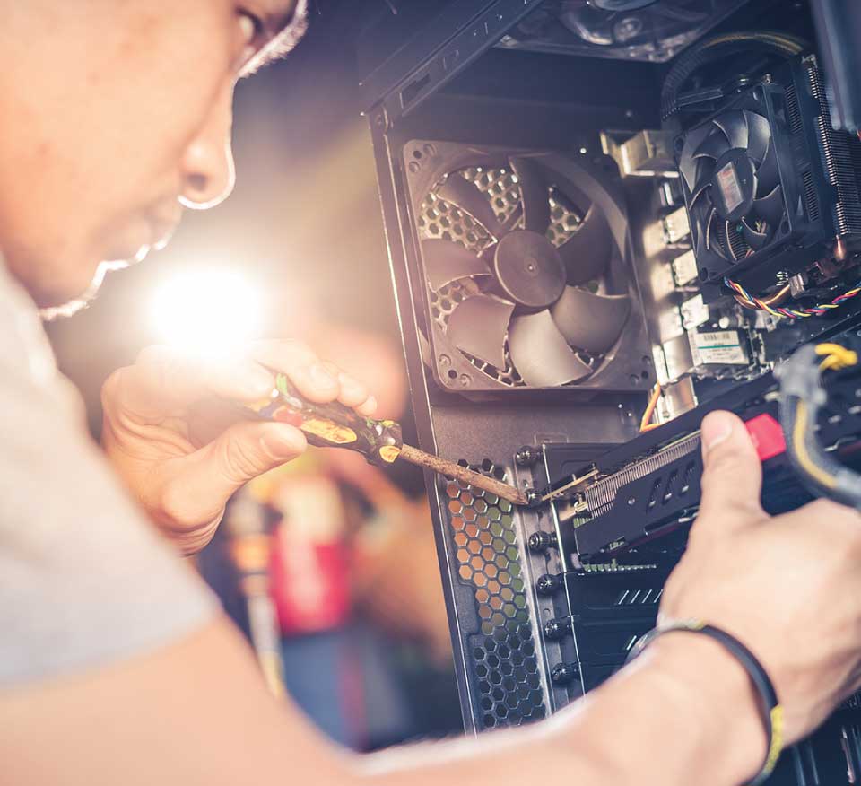 a tech fixing a desktop computer