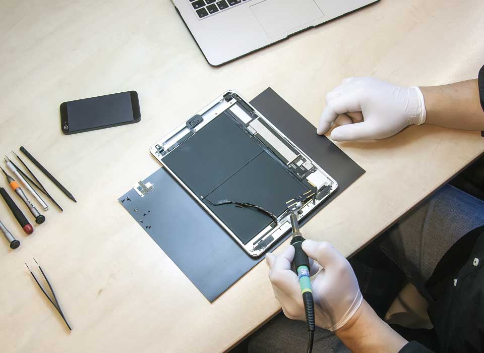 a tech fixing a broken tablet